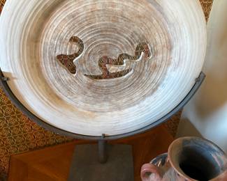 Large pottery plate on metal stand