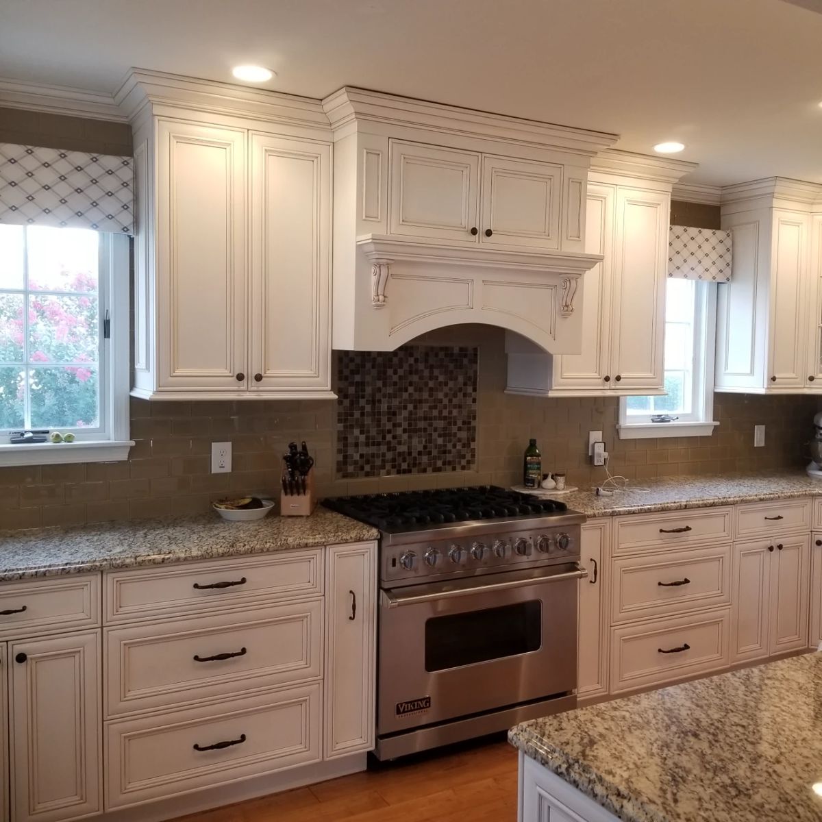 Kitchen includes cabinetry, appliance facings & range hood