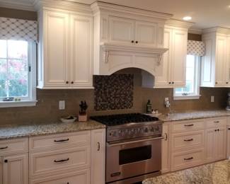 Kitchen includes cabinetry, appliance facings & range hood