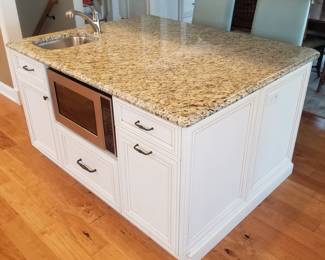Kitchen island features storage on both sides