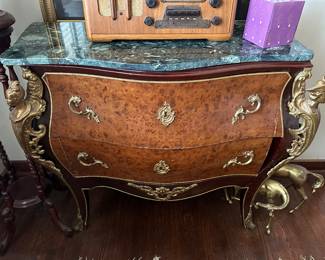 French burl commode with green marble top, caryatids on front corners, and missing a piece of the lower drawer