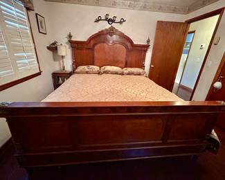 king bed with wooden side rails, headboard and footboard.