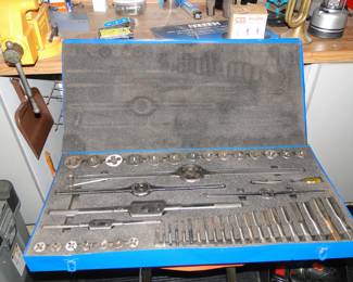 Big huge yellow vice, and small brown dust pan. The large blue box contains a tap and die set