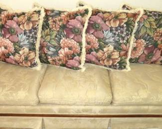 Cream Upholstery Sofa with Floral Back Pillows & Wood Trim