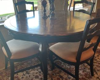 round table with four upholstered chairs