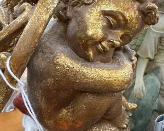 Sleeping golden cherub statue