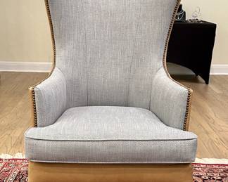 Bassett contemporary curved wing chair from the Whitney collection. Leather saddle stitch sides, back, and apron with nail head trim. There are two chairs both in near unused condition  