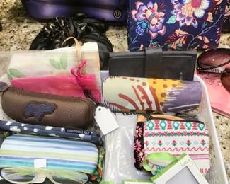 Ladies vanity boxes and bags, trinkets and pouches, sunglasses, mirrors and perfumes.