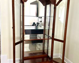 Cherry French style display cabinet. Etched glass doors, mirrored back, glass shelves, brass pulls.
