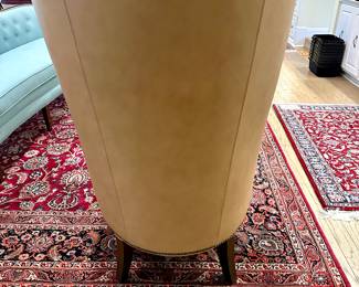 Bassett contemporary curved wing chair from the Whitney collection. Leather saddle stitch sides, back, and apron with nail head trim. There are two chairs both in near unused condition  