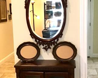 Oval foliate mirror with mahogany finish, wide beveled edges.  Charming lighted bookcase/display cabinet in a rich mahogany finish. Glass front and sides.