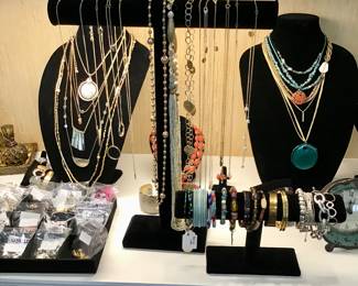 A wide and fabulous assortment of costume jewelry. Bracelets, necklaces, rings, In gold and silver tone, Rhinestone, beaded, hammered, pearl, brass, and in every color of the rainbow