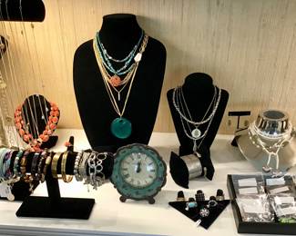 A wide and fabulous assortment of costume jewelry. Bracelets, necklaces, rings, In gold and silver tone, Rhinestone, beaded, hammered, pearl, brass, and in every color of the rainbow