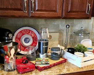 Black KitchenAid mixer, Nutra Bullet blender and accessories plus user guide, Kitchen decor and accessories.