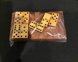 Vintage Phillips two-tone bake light butterscotch and black dominoes with metal ball center and leather case.