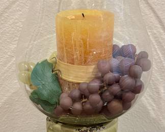 Decor hurricane lamp with candle and grapes.