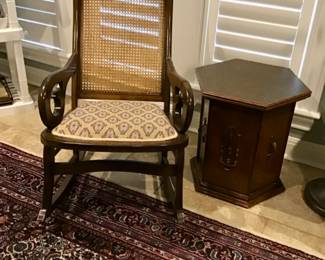 Antique Lincoln rocker with hand caning on back and upholstered spring seat.