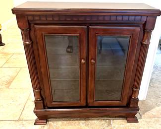 Charming lighted bookcase/display cabinet in a rich mahogany finish. Glass front and sides.