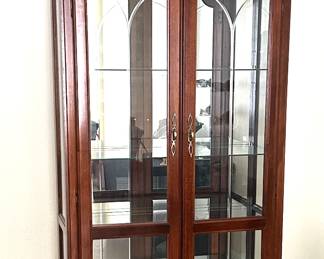 Cherry French style display cabinet. Etched glass doors, mirrored back, glass shelves, brass pulls.