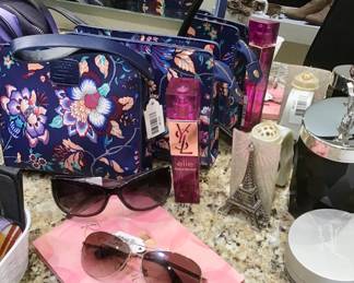 Ladies vanity boxes and bags, trinkets and pouches, sunglasses, mirrors and perfumes.