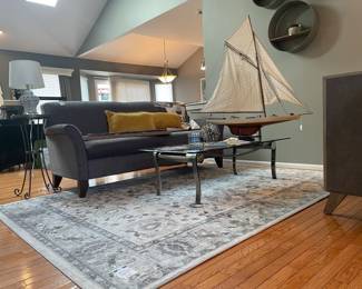 England Inc. Couch, Mikasa Slovenia Cube, Urban Trends metal ribbon art ball, accent pillows, glass coffee table, Gertmenian Brio Malene gray rug, Pier-1 Imports stone top side table, Quatrefoil ceramic lamp, Per Mare-Per Terram & By Land By Sea model ship
