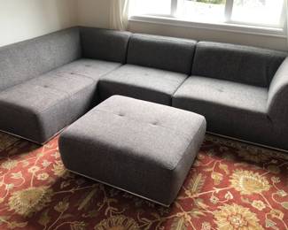 Gray sectional sofa + matching ottoman by Jason Furniture (110” long overall, 27” high at back, left end is 66”L, right end with arm is 34” deep)