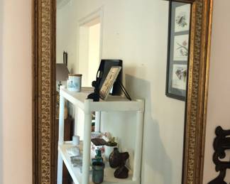 Gilt mirror with leaf design on frame (18” x 24”)