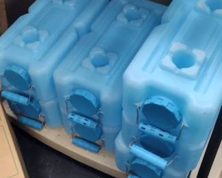 preppers stacking water containers 