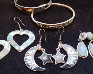 Sterling silver, and abalone much prettier in person 