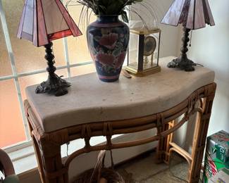 Bamboo console table with two accent chairs, lamps and decor