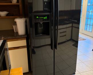 Black LG Side by Side Refrigerator/Freezer. In Door Water/Ice.