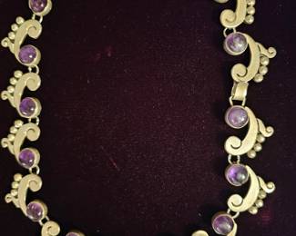 This is a lovely old sterling and Amethyst necklace. Marked TAXCO MARTINEZ STERLING. Crafted by Felipe Martinez. He was a part of the Spratling workshop, colony of artists.