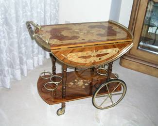 Mid-Century Finely Inlaid Italian Bar (Tea) Cart. The top is ornately decorated with fancy fruitwood veneers, brass gallery rail, rubber tired brass wheels. Excellent condition. Asking $550.