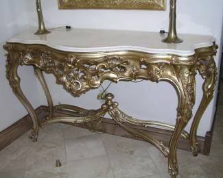 Vintage French Style Marble and Gilded Hardwood Console Table. Extremely ornate gilt-wood pierce carved, serpentine top conforms, legs decorated with cartouches and acanthus. Excellent condition. Asking $1,750.