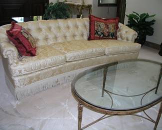 Vintage Button-Tufted Sofa. Crescent shaped, three cushions, button-tufted seat back, floral white and gold covering with chorded fringe, scrolling arms. 95" long. Excellent condition. Asking $495.