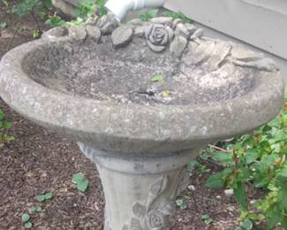 Concrete birdbath with rose motif.