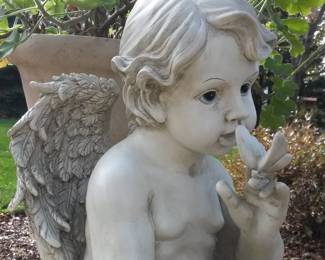 Cherub with butterfly garden statue.