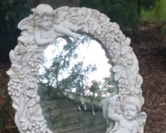 Whimsical double cherub mirror.  Used as a focal point along a garden path.