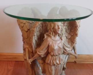 One of a kind Angel End Tables. Three gorgeous angels holding hands and frolicking in the summer sun, carelessly dancing away the afternoon.  Intricate details on faces, wings and gowns make this an exceptional piece.    Cast in fiberglass resin in a ANTIQUE STONE finish  Ogee edge finish on  round 3/8” thick  24" diameter glass top.