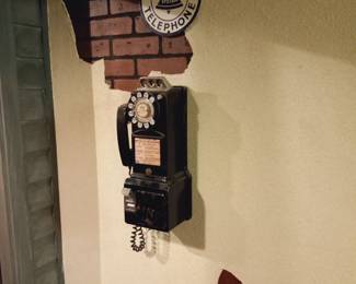 Black rotary pay phone.