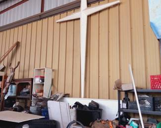 Many items in the warehouse including this large metal cross.  Located in second building.