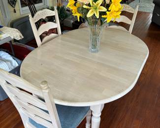 A111 - $150. Off white table with 4 chairs. Measures 48" long (has leaf in adding 11.5" making it 59") x 41.5" wide x 30" tall. 
