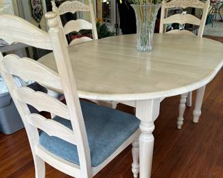 A111 - $150. Off white table with 4 chairs. Measures 48" long (has leaf in adding 11.5" making it 59") x 41.5" wide x 30" tall. 