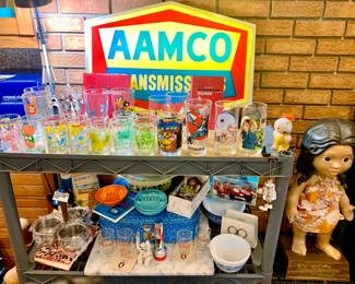 AAMCO Transmission Shop Sign light works. 1950's ashtray's, Stainless and Teak relish server, Pyrex, Vintage suitcase, Dolls in box. Comic juice and water glass's