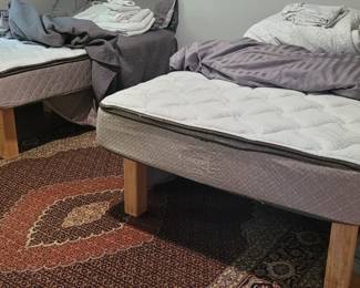 Double mattresses on wooden Crate & Barrel platform frames, sold separately 