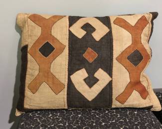 Small pillow with mud cloth case.

African Mud Cloth is a traditional cotton fabric with great cultural significance throughout Africa. Dyed with fermented mud and plant dyes, the ornately patterned fabric takes four days to a week to create, depending on weather conditions.