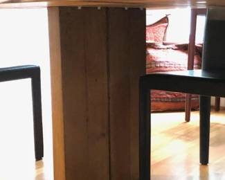 The Crate & Barrel "Dakota" dining table is made of white oak, dimensions 99”x 42".
The eight Crate & Barrel "Folio" chairs are black leather, sold separately 