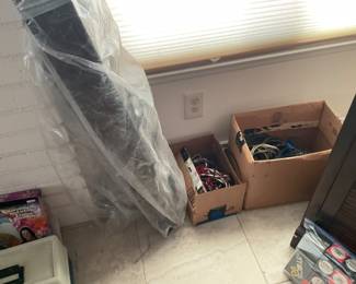 The thing in plastic is an Ethan Allen bridge to connect pieces of lighting, display, etc. we also have a box of cords/cables