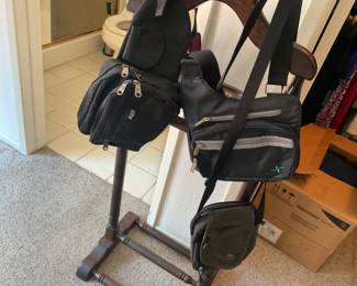 Crossbody and bum bags, hanging on valet suit rack