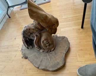 This is upside down-hanging wood carving of cherub/angel, the top portion would be a shelf when hanging